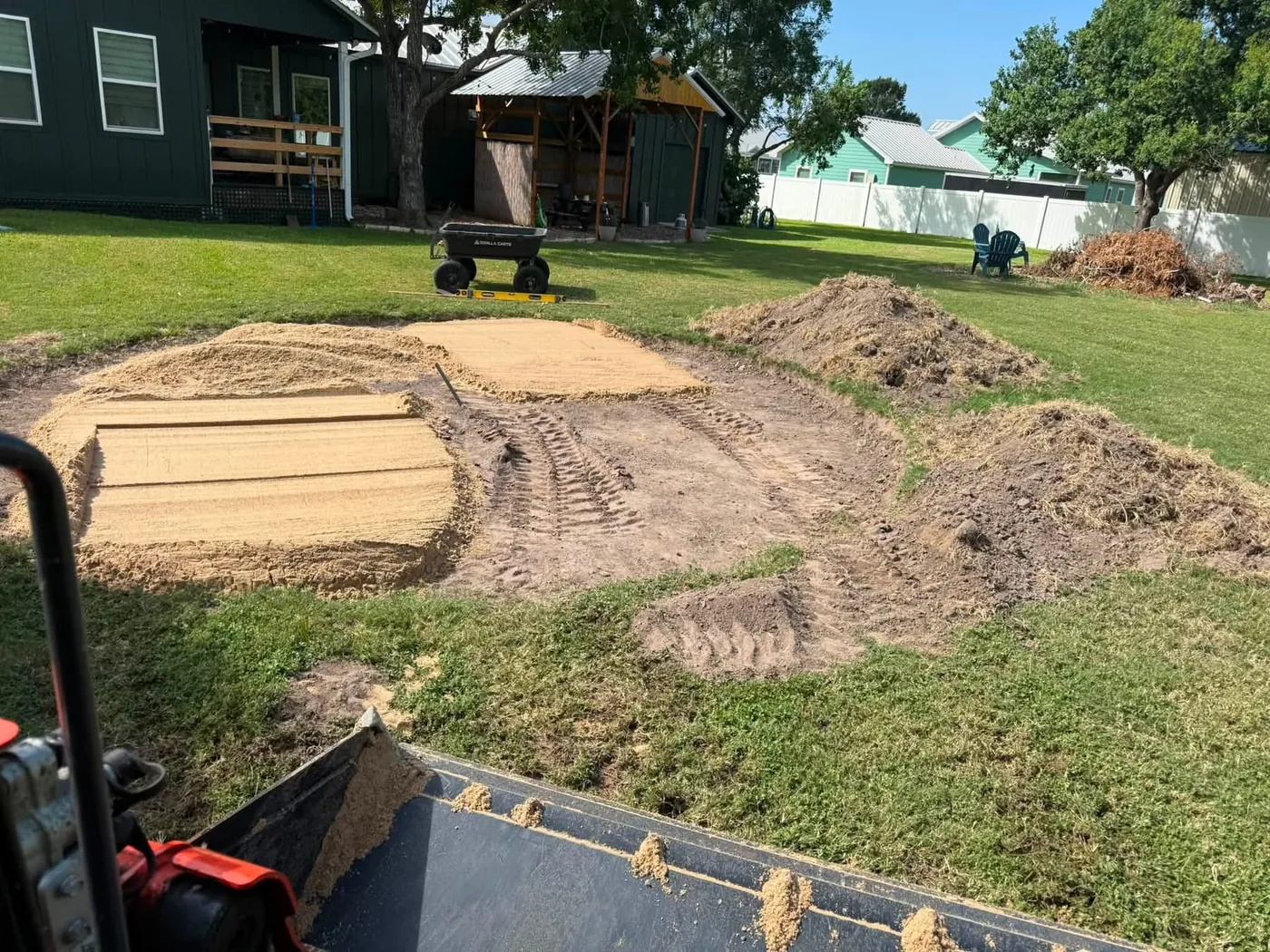 Skid steer grading a yard